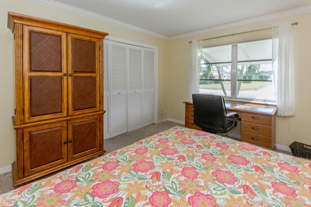 carpeted bedroom featuring crown molding and a closet