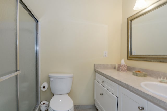 bathroom with vanity, toilet, and walk in shower