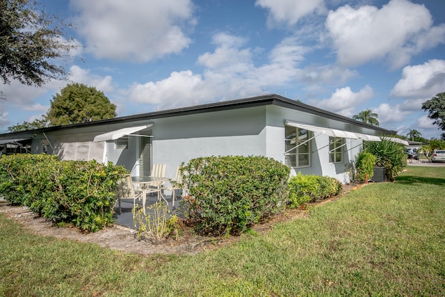 view of side of home with a lawn and cooling unit