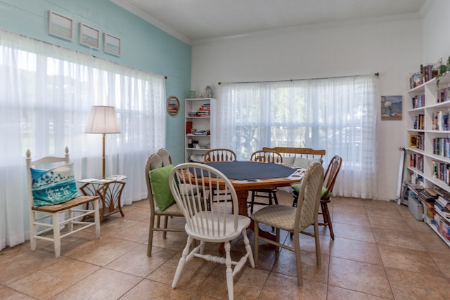 tiled dining area with plenty of natural light and crown molding