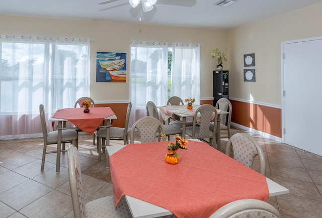 dining space featuring ceiling fan and light tile patterned flooring