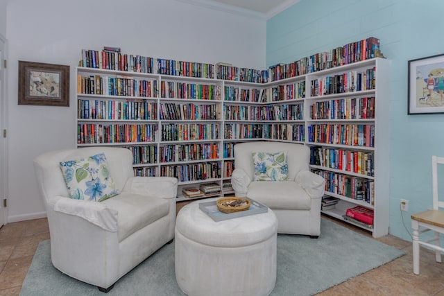 sitting room with tile patterned flooring and crown molding