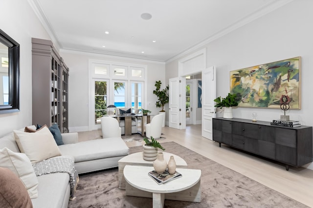 living room with light hardwood / wood-style flooring and crown molding