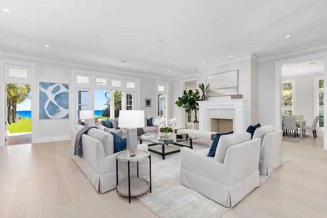 living room featuring light wood-type flooring and ornamental molding