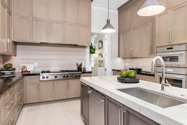 kitchen with decorative backsplash, stainless steel appliances, crown molding, sink, and decorative light fixtures