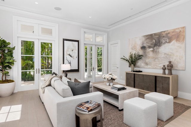 living room featuring light wood-type flooring, crown molding, and french doors