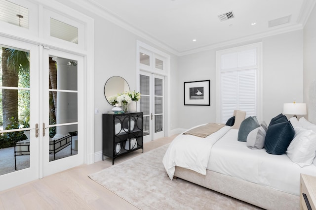 bedroom with access to outside, french doors, ornamental molding, and light wood-type flooring