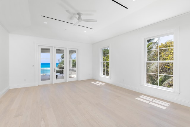 empty room with light hardwood / wood-style flooring and ceiling fan