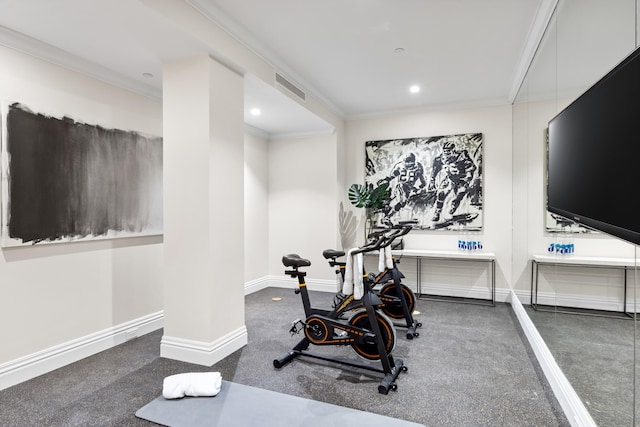 workout area with dark carpet and ornamental molding