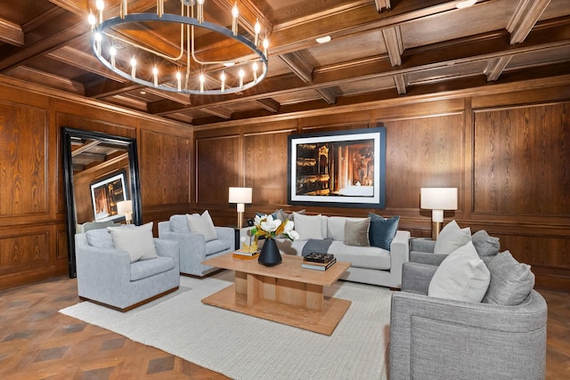 living room with wood walls, coffered ceiling, ornamental molding, a notable chandelier, and beam ceiling