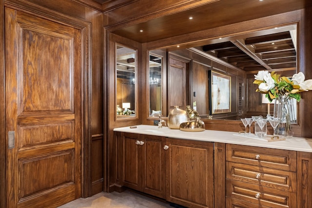 bathroom featuring wood walls and vanity