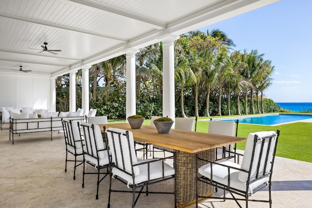 view of patio / terrace with ceiling fan and a water view