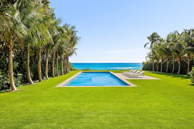 view of pool featuring a yard and a water view