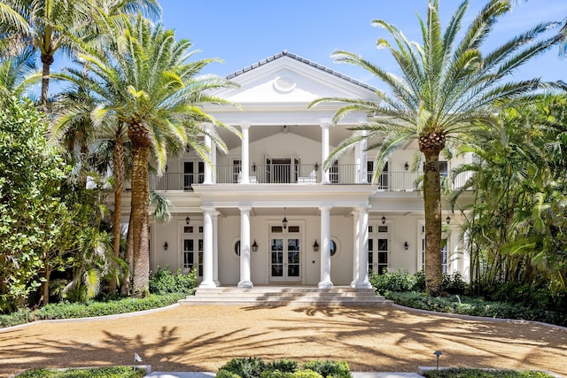 view of front of home featuring french doors, a balcony, and ceiling fan