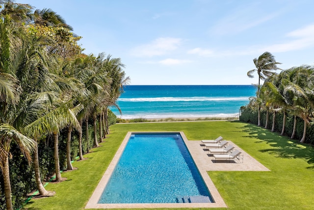 view of swimming pool featuring a water view and a yard