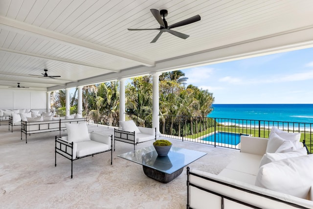 view of patio featuring outdoor lounge area, a water view, and a fenced in pool