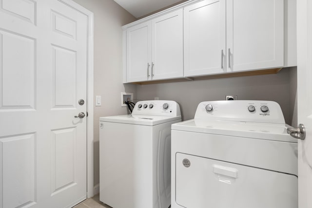 washroom with cabinets and separate washer and dryer