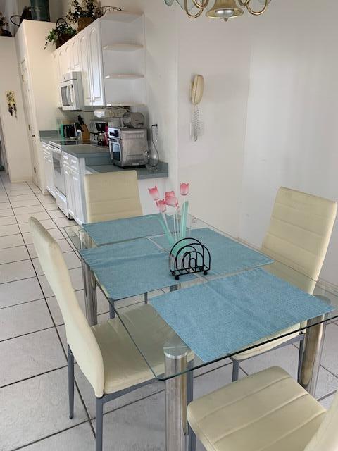 dining area with light tile patterned floors