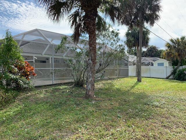 view of yard with glass enclosure