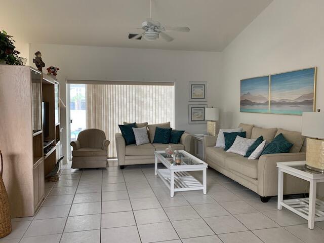 tiled living room with ceiling fan