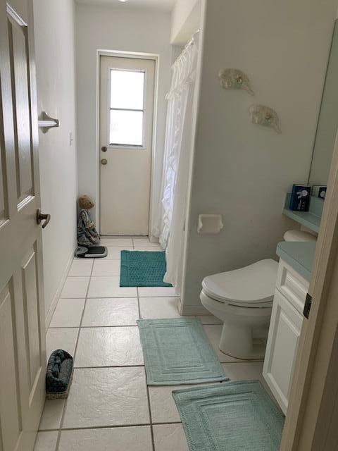 bathroom featuring vanity, toilet, and tile patterned flooring