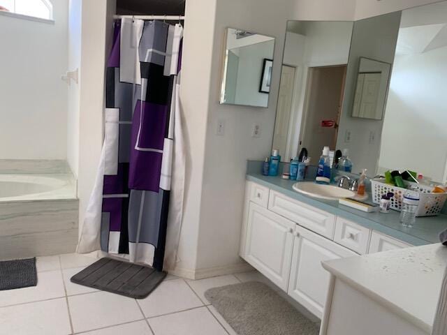 bathroom with vanity, tile patterned floors, and a bathtub