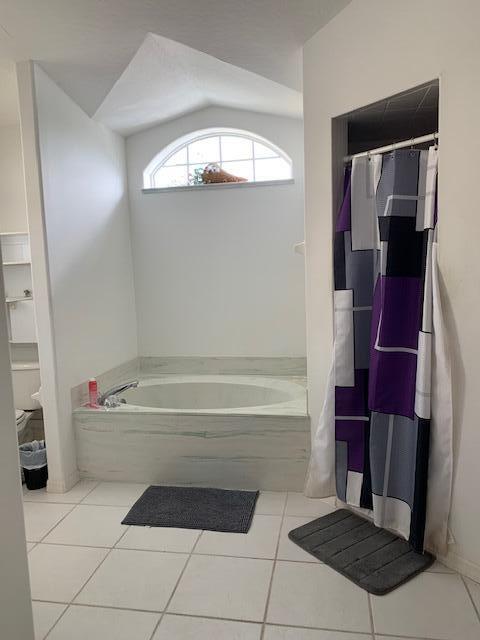 bathroom with tile patterned floors and separate shower and tub