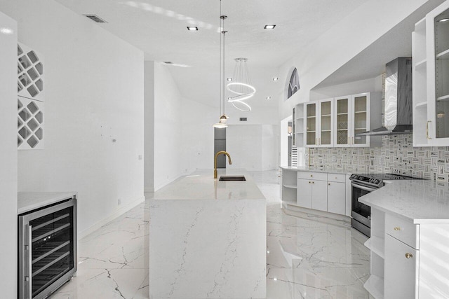 kitchen with wall chimney exhaust hood, stainless steel electric range oven, beverage cooler, decorative light fixtures, and white cabinetry