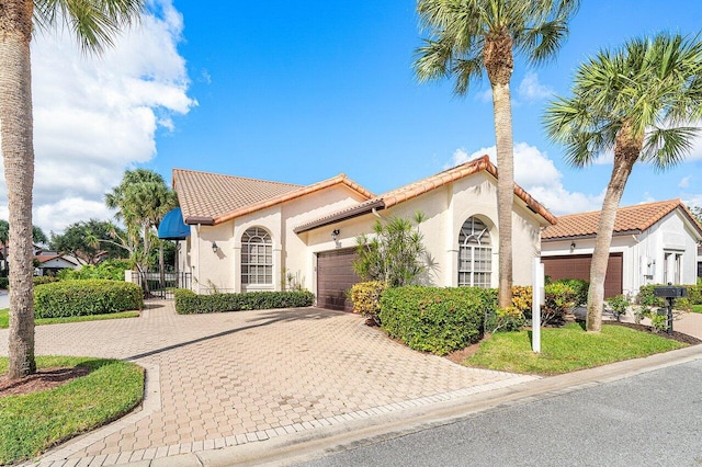 mediterranean / spanish house with a garage