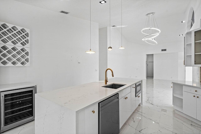 kitchen with white cabinets, pendant lighting, beverage cooler, and sink