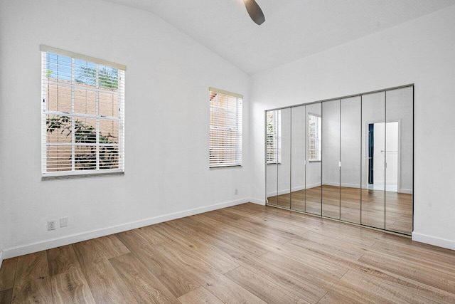 unfurnished bedroom with multiple windows, ceiling fan, and light hardwood / wood-style floors