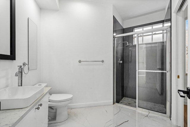 bathroom with vanity, toilet, and a shower with door