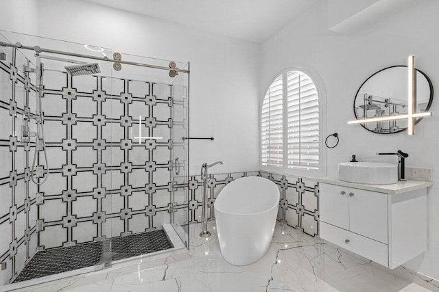 bathroom featuring separate shower and tub, vanity, and tile walls