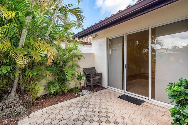 doorway to property with a patio area