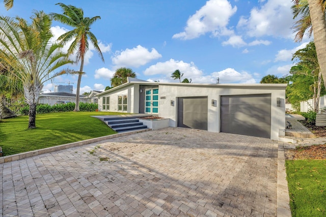 view of front of home featuring a garage and a front lawn