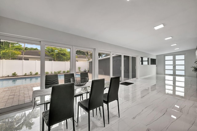 dining space with french doors and vaulted ceiling