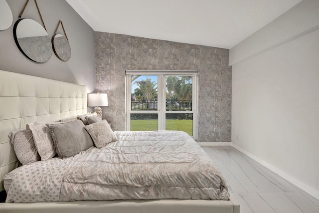 bedroom featuring light hardwood / wood-style flooring and lofted ceiling