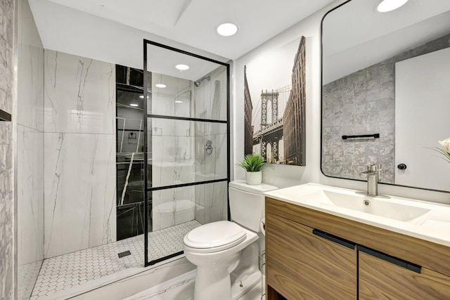 bathroom with an enclosed shower, vanity, toilet, and tile walls