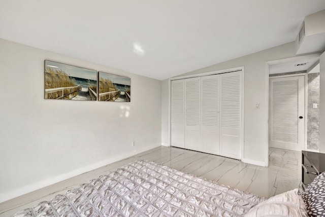 bedroom with vaulted ceiling and a closet