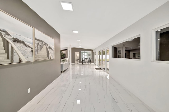 hallway featuring vaulted ceiling