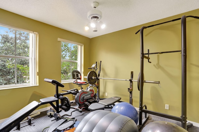 exercise room with a textured ceiling