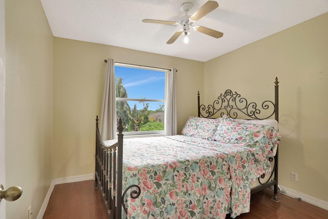 bedroom with ceiling fan and dark hardwood / wood-style floors