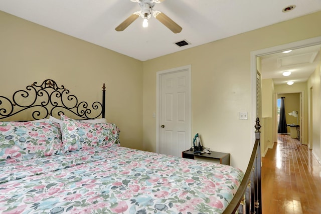 bedroom with ceiling fan and wood-type flooring