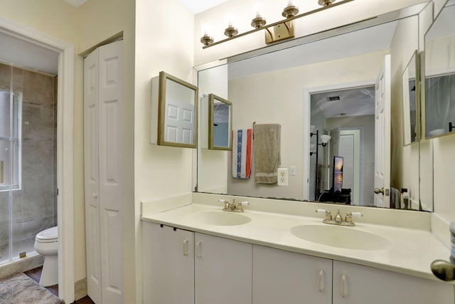 bathroom with vanity, an enclosed shower, and toilet