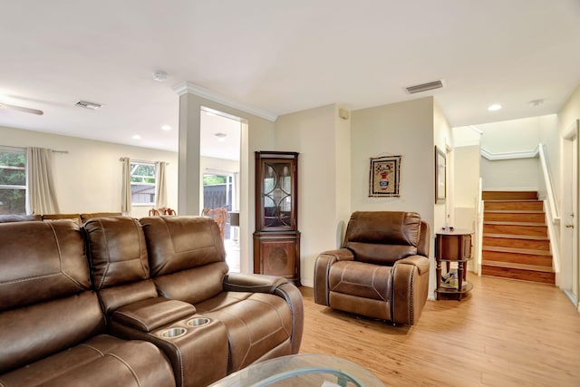 living room featuring light hardwood / wood-style floors and ornamental molding