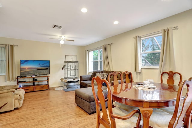 dining area with ceiling fan and light hardwood / wood-style flooring