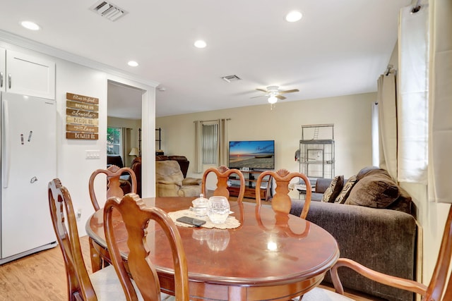 dining space featuring light hardwood / wood-style flooring and ceiling fan