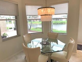 dining room featuring a water view, a wealth of natural light, and a notable chandelier