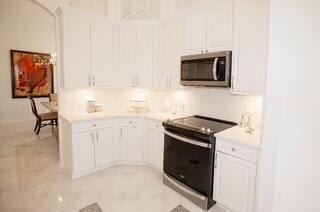 kitchen featuring appliances with stainless steel finishes and white cabinetry