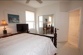 bedroom with light colored carpet and ceiling fan